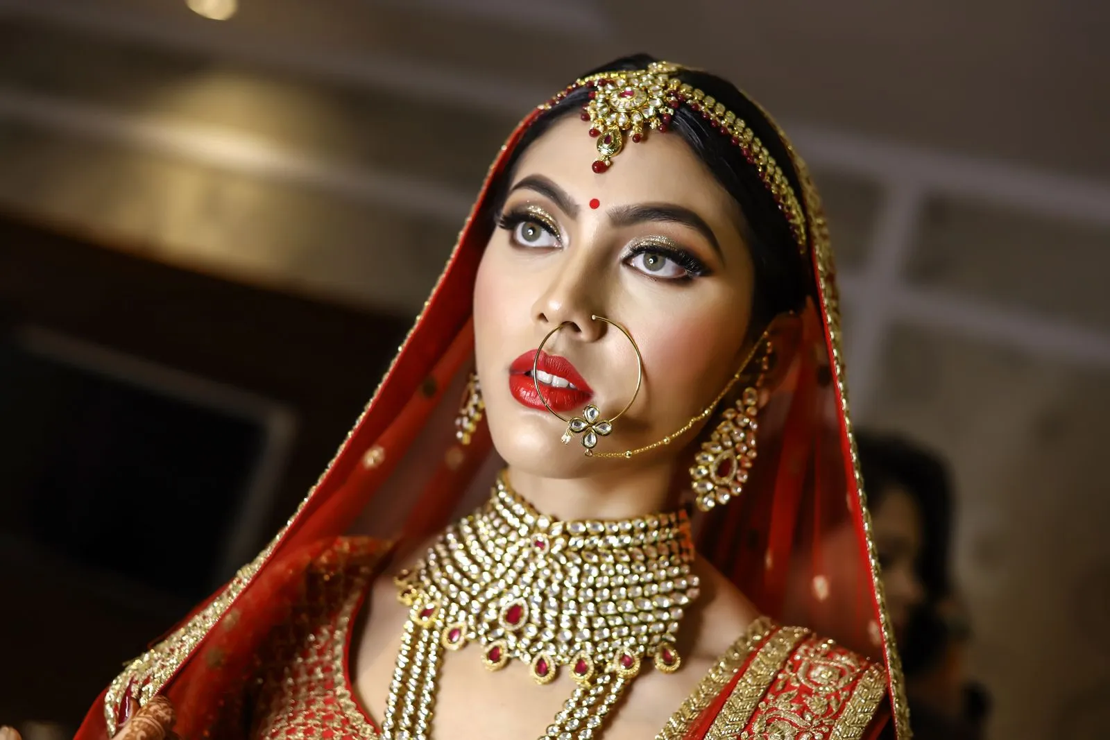 Beautiful Indian bride in traditional attire and jewelry, showcasing elegance.